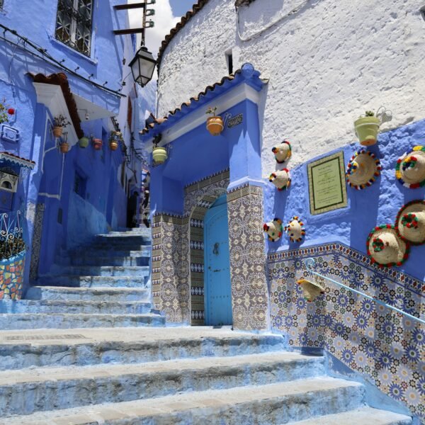 Explore the captivating blue streets of Chefchaouen, adorned with colorful pottery and traditional tiles.