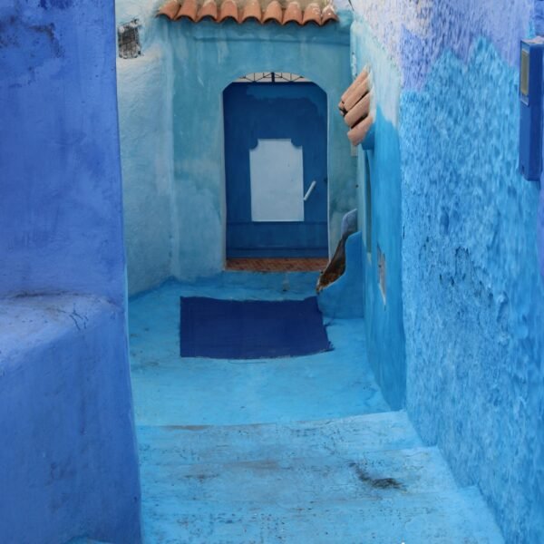 A vivid blue passageway in Chefchaouen, Morocco, showcasing stunning traditional architecture.