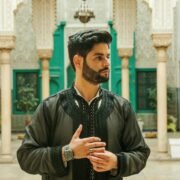 Portrait of a man in traditional Moroccan attire inside a stunning architectural landmark. Perfect for cultural themes.